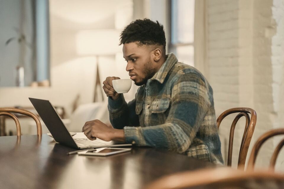 A business owner catching up on the news over coffee